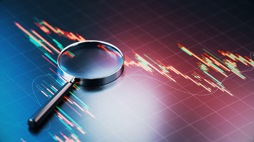 Magnifying glass on finiancial graph chart