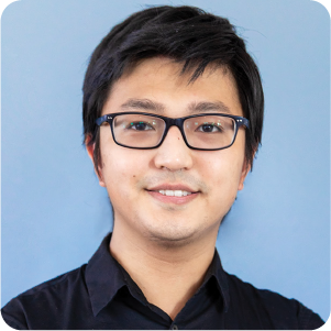 A color portrait of a man with glasses.