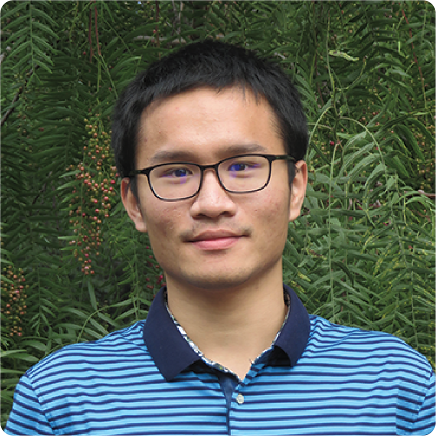 Color photo of a man smiling for a photo, outdoors.