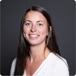 A color photo of a woman smiling for a portrait.