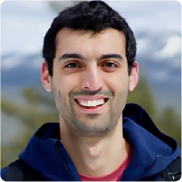 A color photo of a man smiling for a photo.