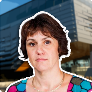 A color photo of a woman with a white outline in front of a blurred building.