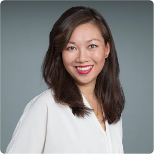 A color portrait of Judy Zhong in front of a grey background.
