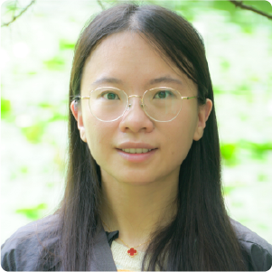 A color photo of a woman smiling for a photo.