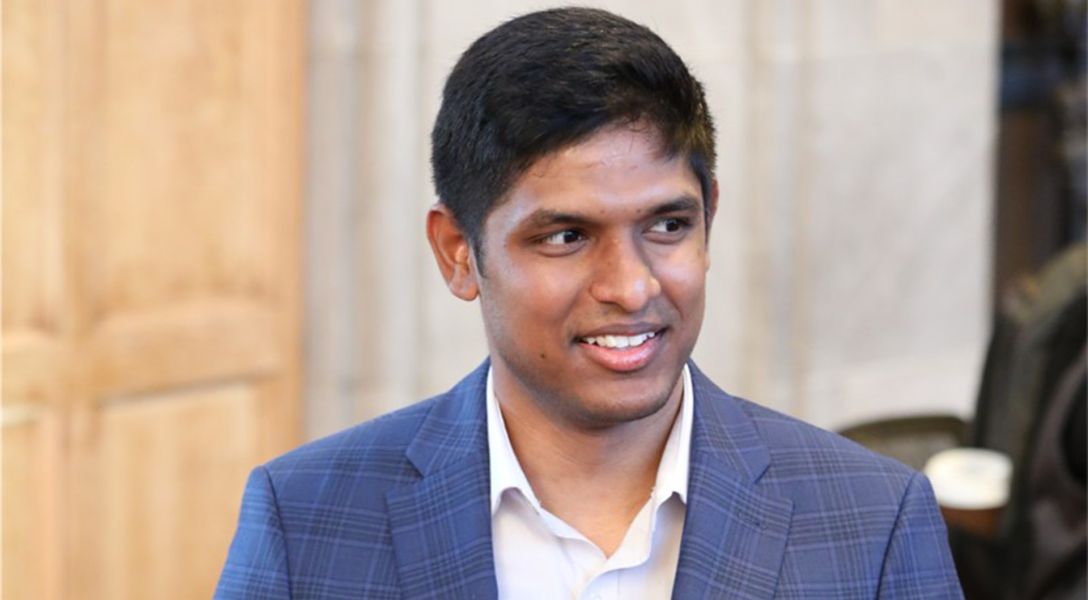 A color photo of a man smiling for a photo