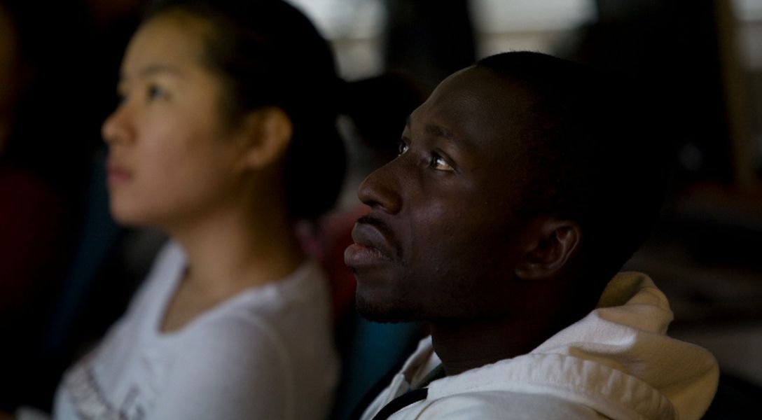 A color photo showing students listening in class