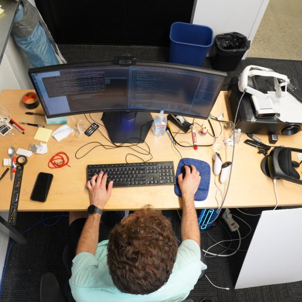 birds eye view of a male student working on a computer at a desk