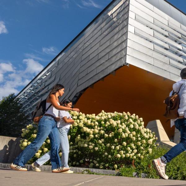 three students walk past Gates Gall