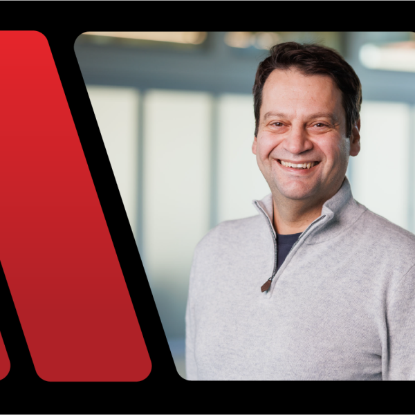 A color photo of a man smiling for a photo.