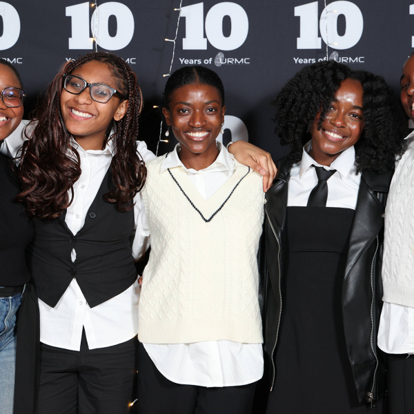 A color photo showing a group of women smiling for a photo.