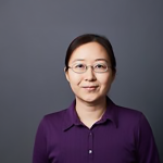 A color photo of a woman smiling for a photo.