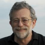 color portrait of main in glasses, greying hair