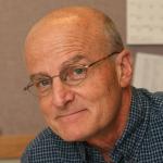 color portrait of man with glasses, greying hair