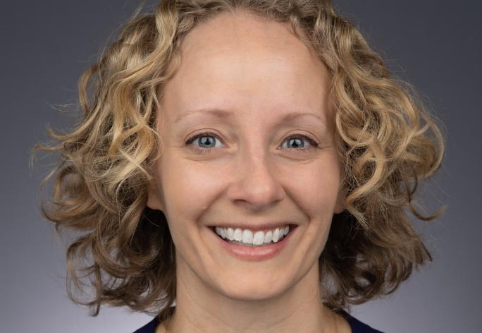 woman with blonde curly hair smiling