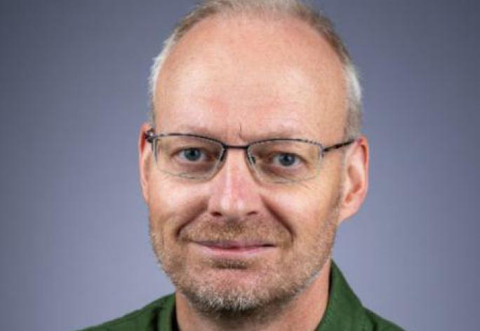 Portrait of man with glasses and graying hair 