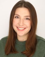 A color photo of a woman smiling for a photo
