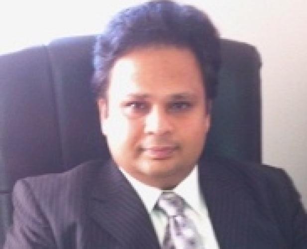 Man in suit sitting in chair