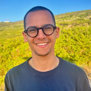 A color photo of a man smiling for a photo