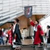 Newest ‘stewards’ of the Bowers legacy congratulated at recognition ceremonies A color photo showing people walking to Cornell University graduation behind the Cornell Bowers flag