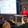 A color photo of a man giving a presentation. by Luke Stewart - Cornell Bowers