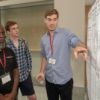A student explains his research during a poster session held in conjunction with the 2018 Cornell Day of Statistics.