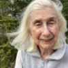 A color photo of a woman smiling for a photo