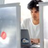 A color photo of a man working at a computer