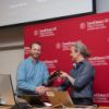 David Matteson, associate department chair and associate professor in statistics and data science, receives a Research Excellence Award from Thorsten Joachims, associate dean for research at Cornell Bowers CIS.